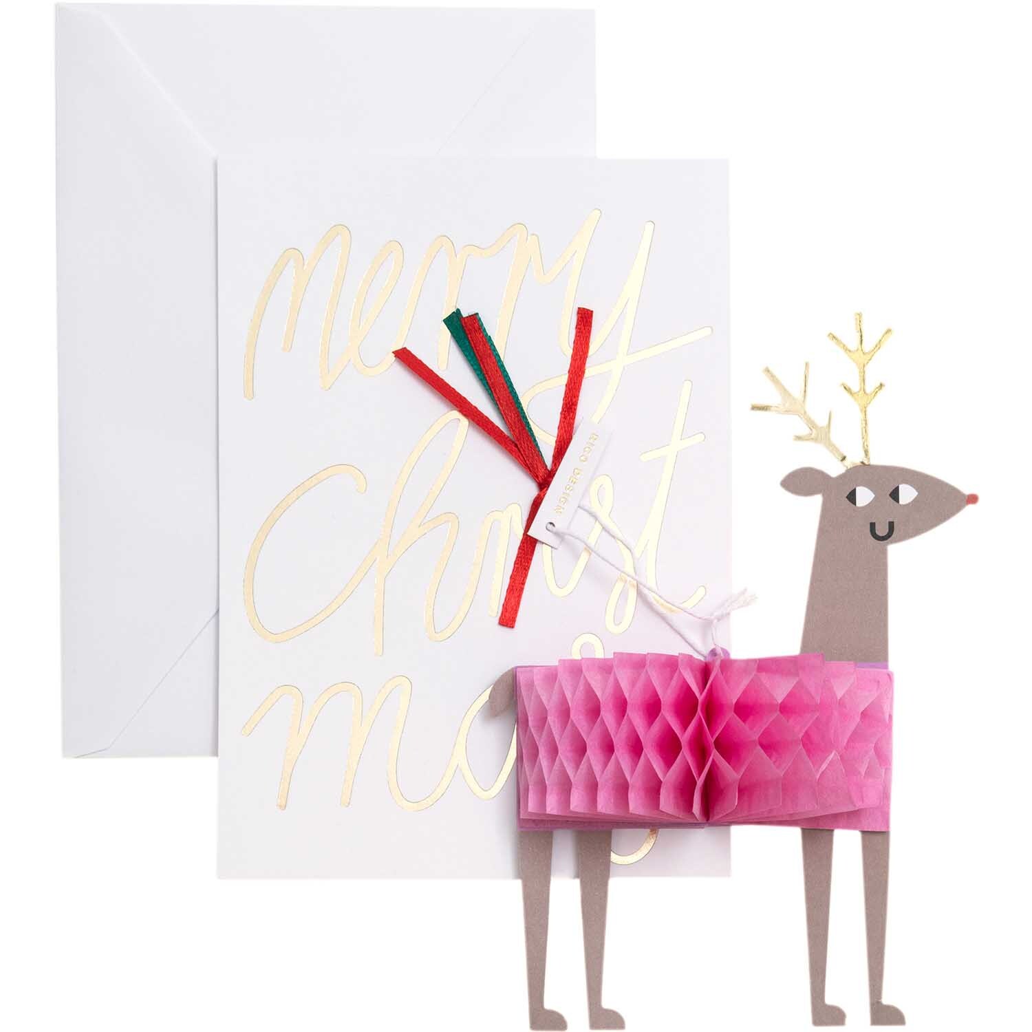 Paper Poetry Kartenset mit Pop-Up Anhänger Rentier B6 zeigt ein Rentier mit pinkem Körper vor einer Weihnachtskarte.