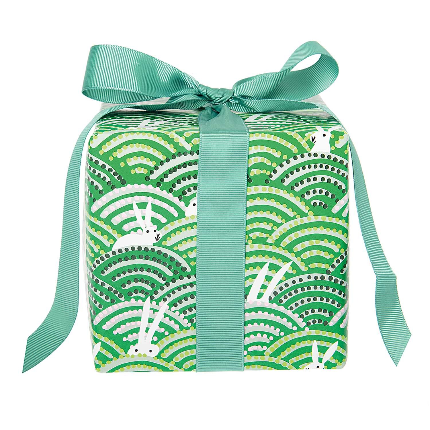 Paper Poetry Geschenkpapier Bunny Hop Hasen im Feld 70cm 2m von Rico Design Paper Poetry Geschenkpapier zeigt Hasen im Feld mit grünem Muster, verpackt mit Schleife. Ideal für Ostern. Marke: Rico Design.