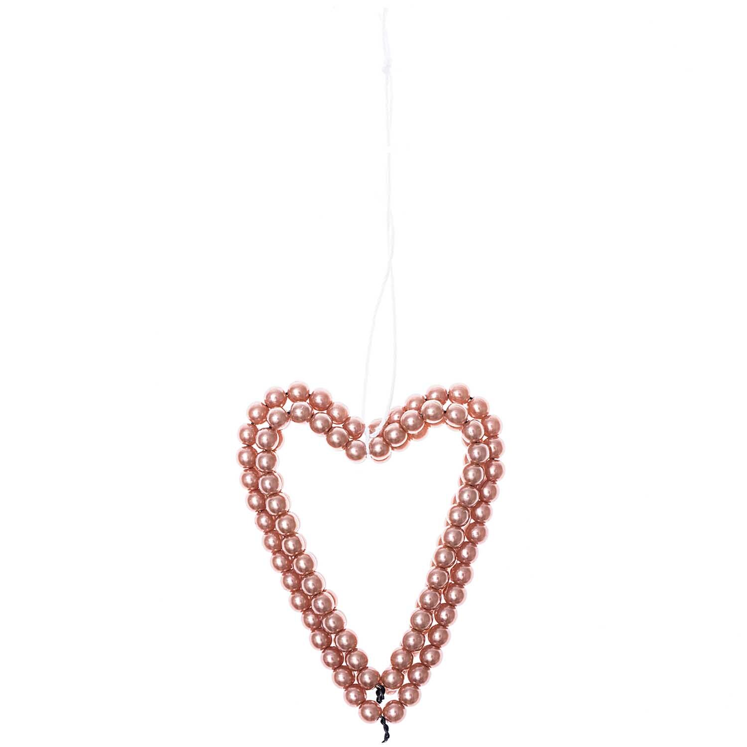 Perlenhänger Herz groß rosegold von Rico Design: Ein herzförmiger Anhänger aus rosa Perlen, ideal als dekorativer Schmuck für besondere Anlässe.
