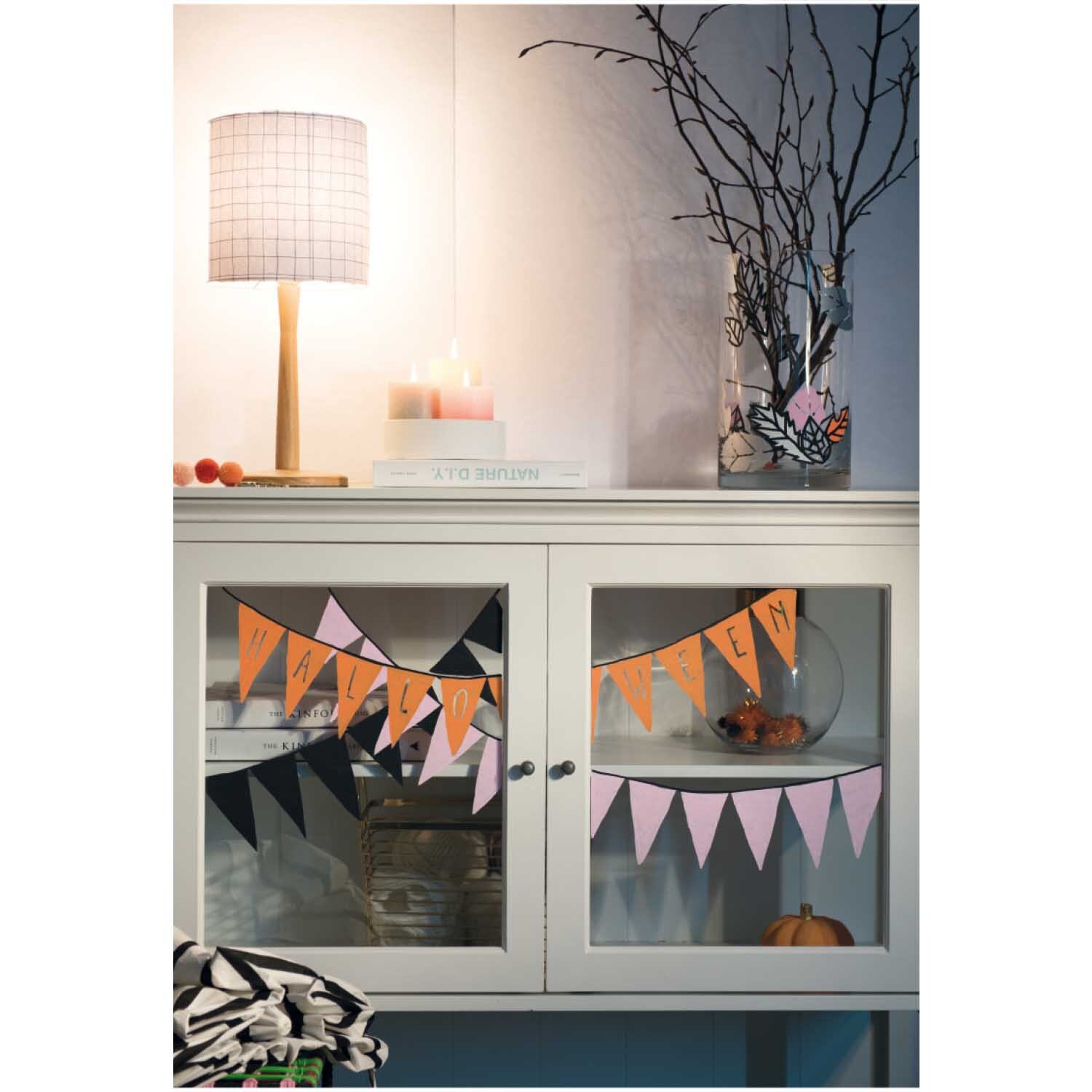 Kreidestifte Flüssigkreide Set Pastell 3mm 4 Farben von Rico Design Kreidestifte Flüssigkreide Set Pastell 3mm 4 Farben von Rico Design auf einem dekorierten Schrank mit Halloween-Girlanden und Lampe.