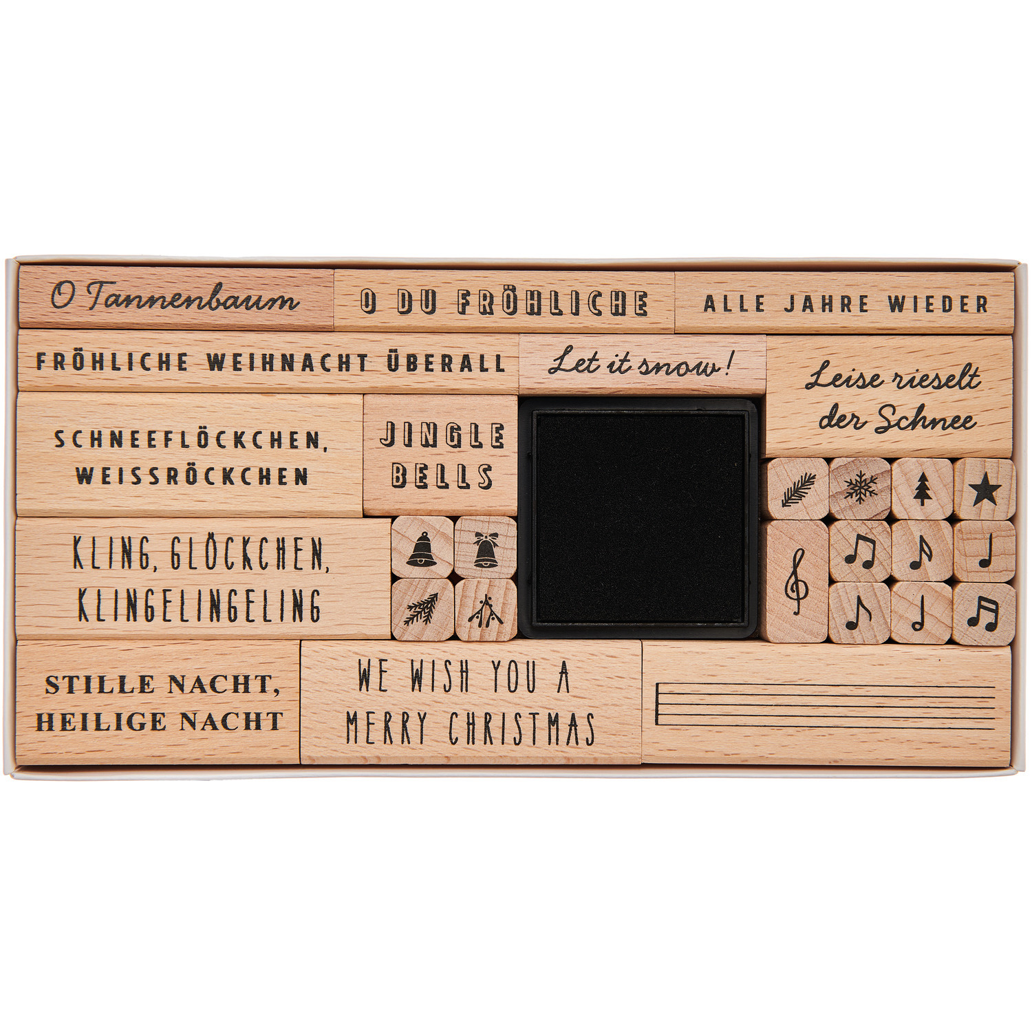 Paper Poetry Stempelset Weihnachtslieder, 28-teilig von Rico Design, zeigt Holzstempel mit Weihnachtsmotiven und Liedtexten auf einem Tablett.
