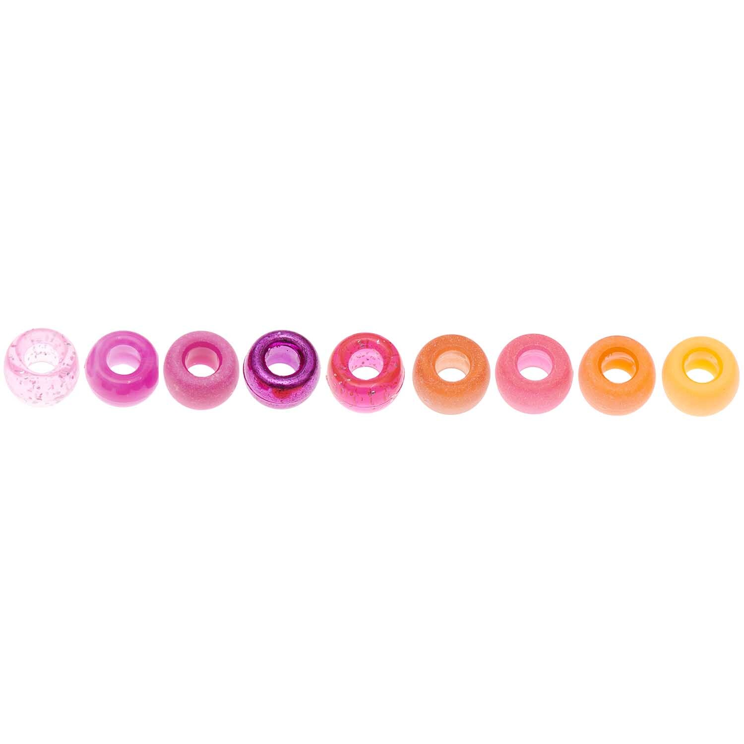 Itoshii - Ponii Beads Beere Mix 9x6mm, 80 Stück, von Rico Design. Bunte Perlen in Rosa- und Orangetönen in einer Reihe angeordnet.