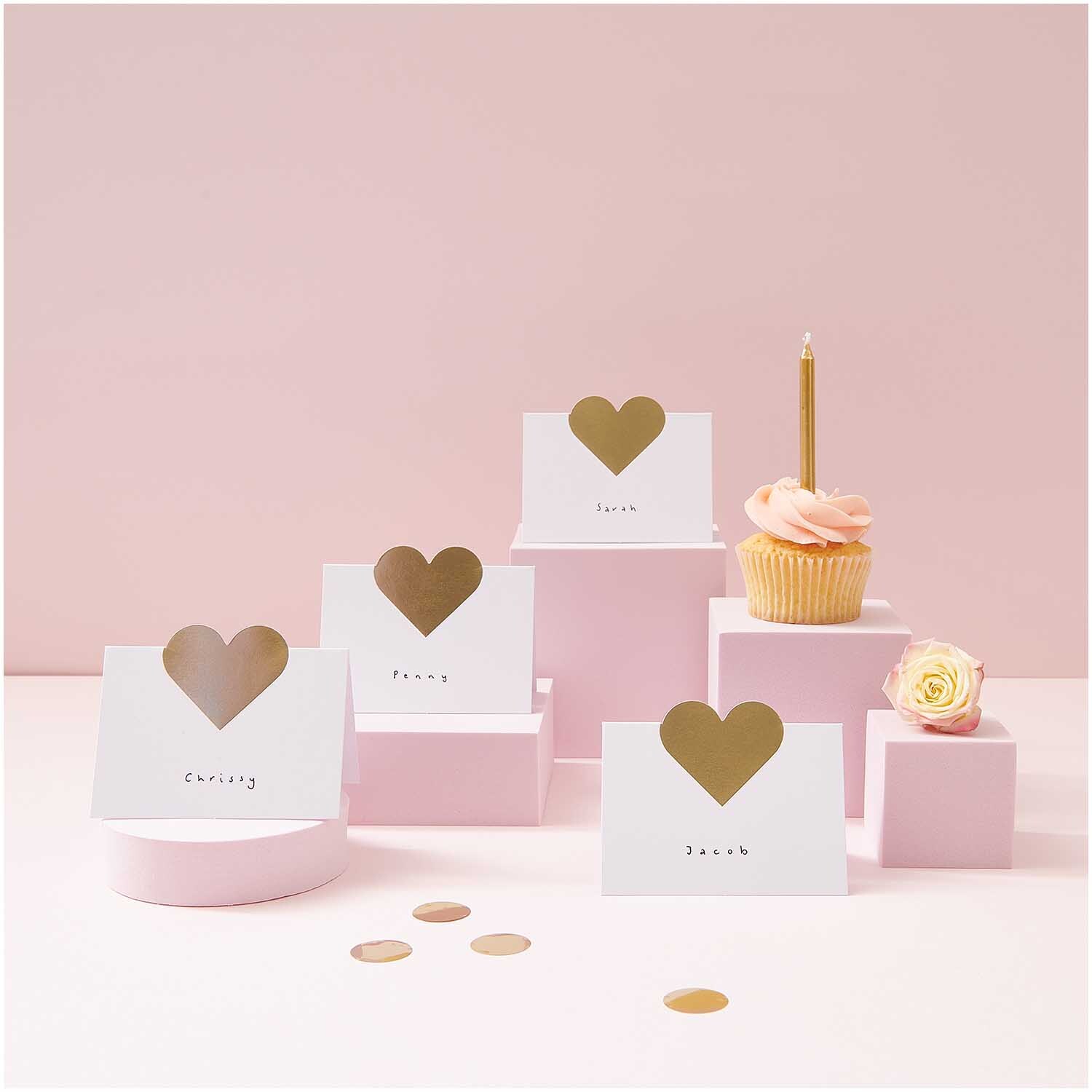 Paper Poetry Tischkarten Herzen 9x12,6cm von Rico Design Paper Poetry Tischkarten mit Herzmotiv auf rosa Podesten, dekoriert mit Cupcake und Blume.