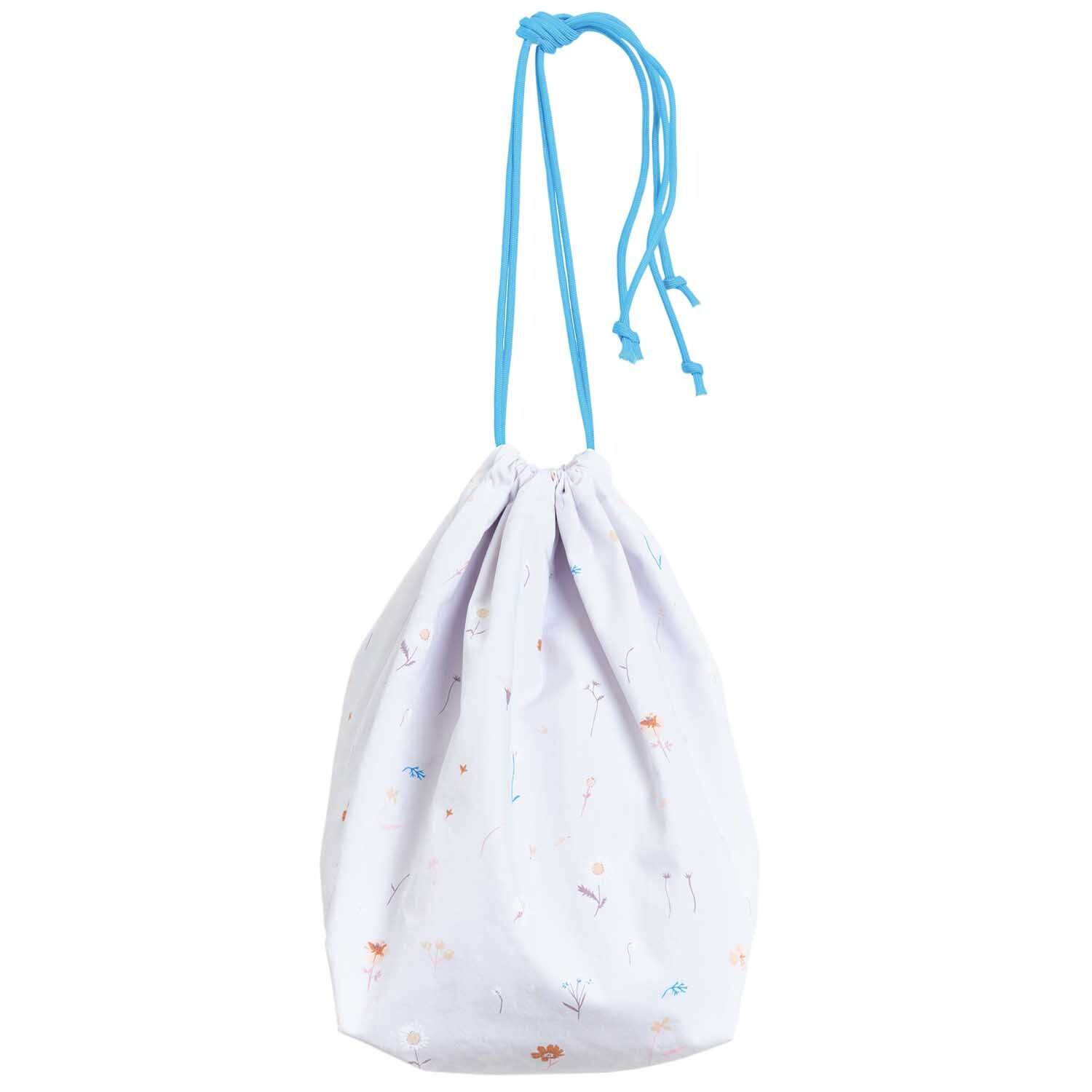 Meterware Druckstoff Streublumen hellgrau von Rico Design Meterware Druckstoff Streublumen hellgrau: Stoffbeutel mit blauen Kordeln und zarten Blumenmustern. Ideal für kreative Nähprojekte.