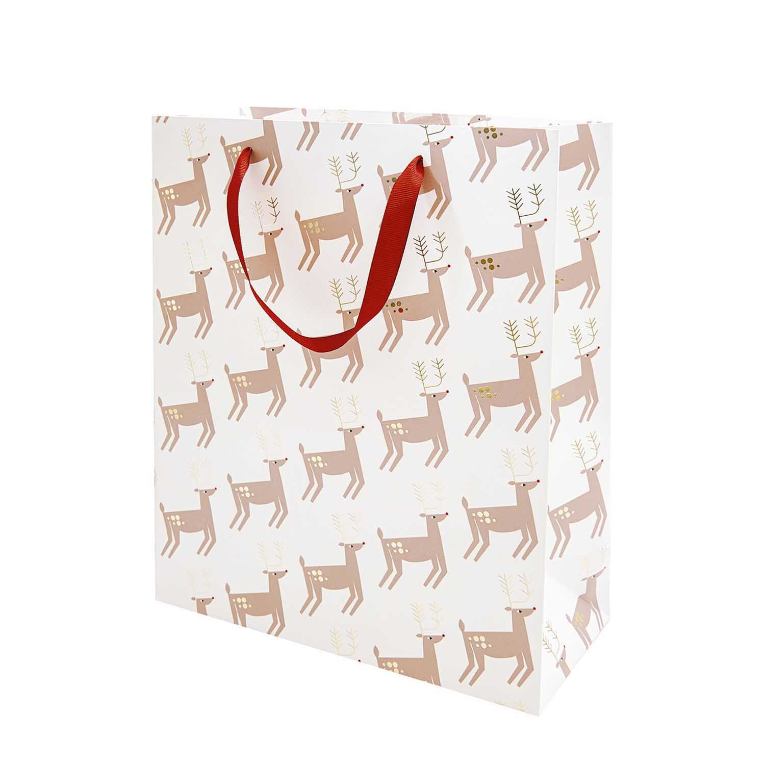 Paper Poetry Geschenktüte mit Rentiermuster und roten Griffen von Rico Design, ideal für festliche Anlässe.