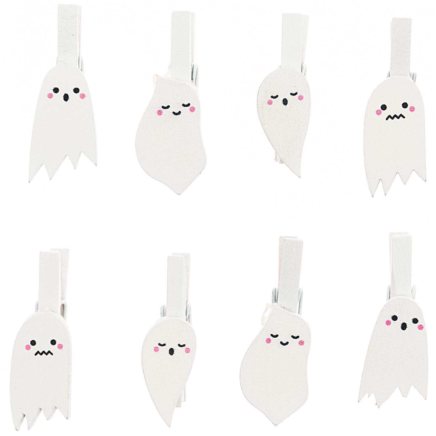 Holzclips Gespenster Mix weiß 8 Stück von Rico Design zeigen niedliche Geistergesichter auf weißen Clips. Ideal für kreative Dekorationen.