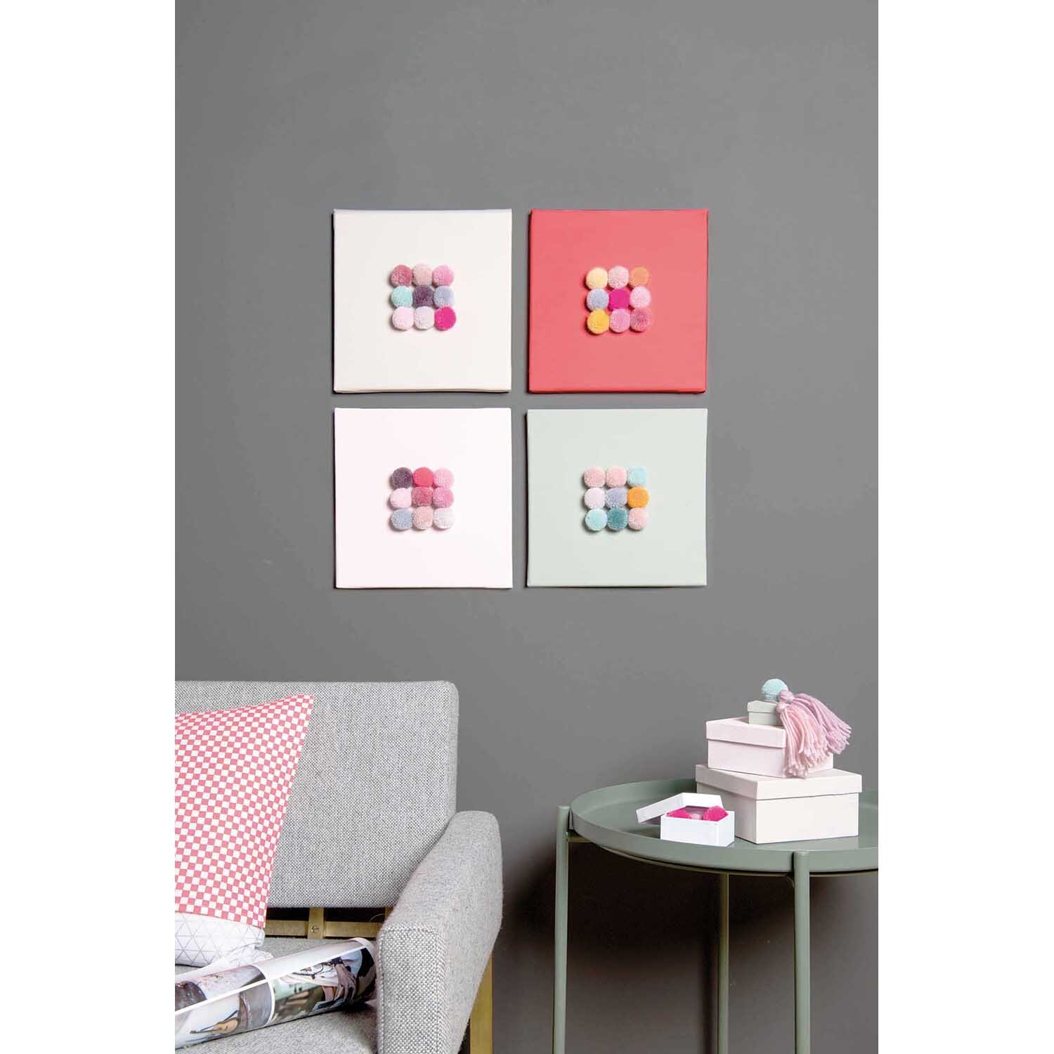 Garn Pompons 24 Stück Farbe Natur Mix von Rico Design Garn Pompons 24 Stück von Rico Design in verschiedenen Farbmixen, dekorativ an der Wand arrangiert.