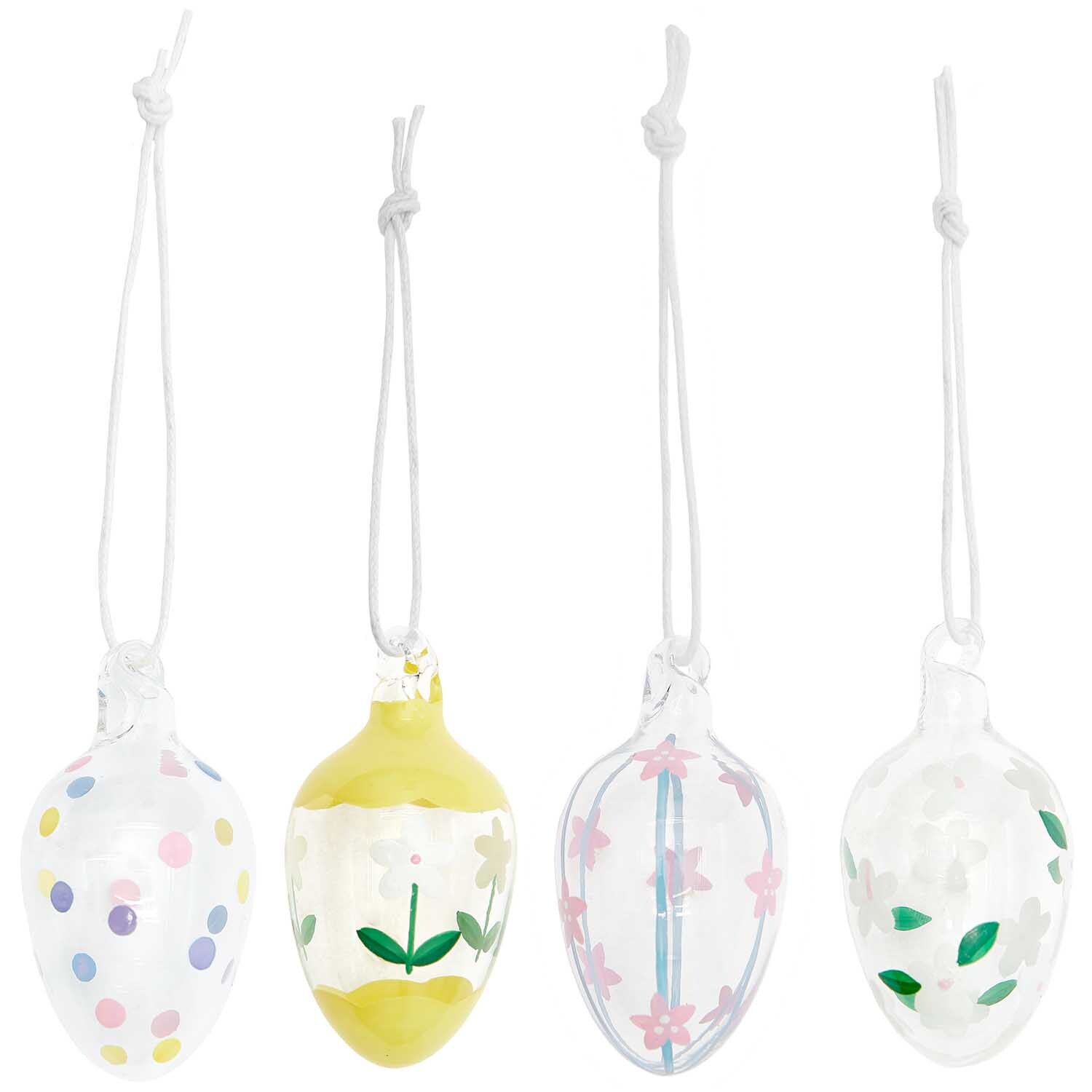 Glas Eier transparent handbemalt 4 Stück Ø 3cm von Rico Design, mit bunten Mustern und Blumenmotiven. Ideal für dekorative Zwecke.