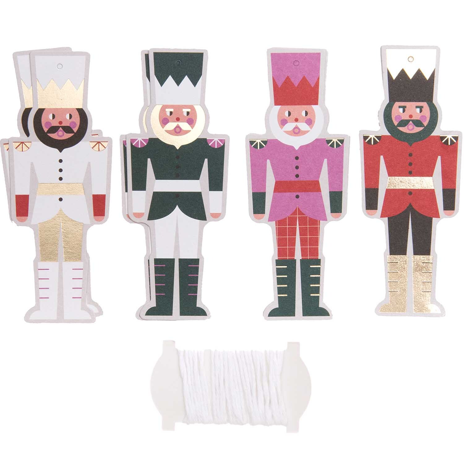 Paper Poetry Papieranhänger Nussknacker, 8 Stück, zeigen bunte Nussknackerfiguren mit Schnur. Ideal für kreative Dekorationen.