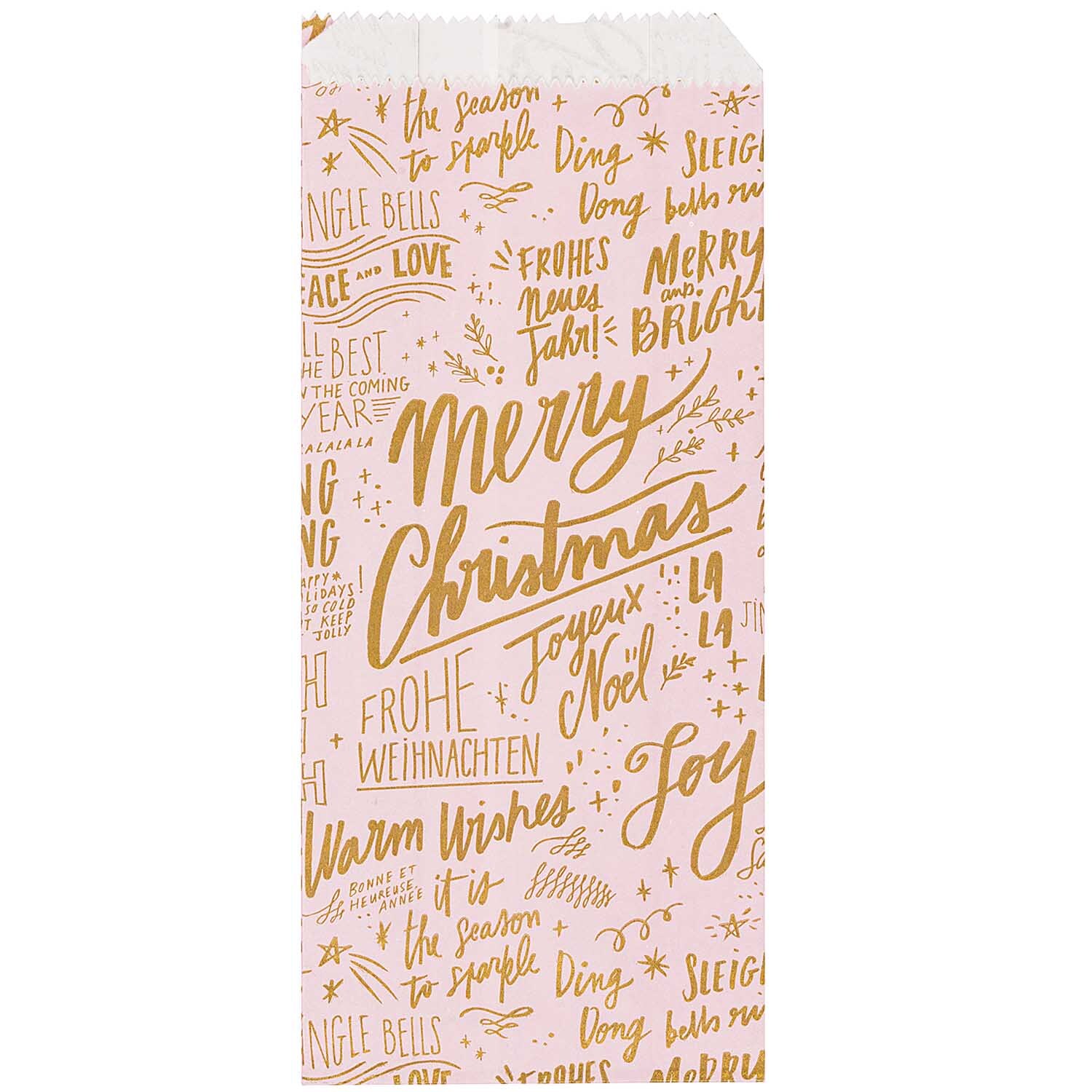 Paper Poetry Bastelset Papiertüten-Sterne Jolly Christmas groß zeigt eine rosa Tüte mit goldenen Weihnachtsgrüßen und festlichen Motiven.