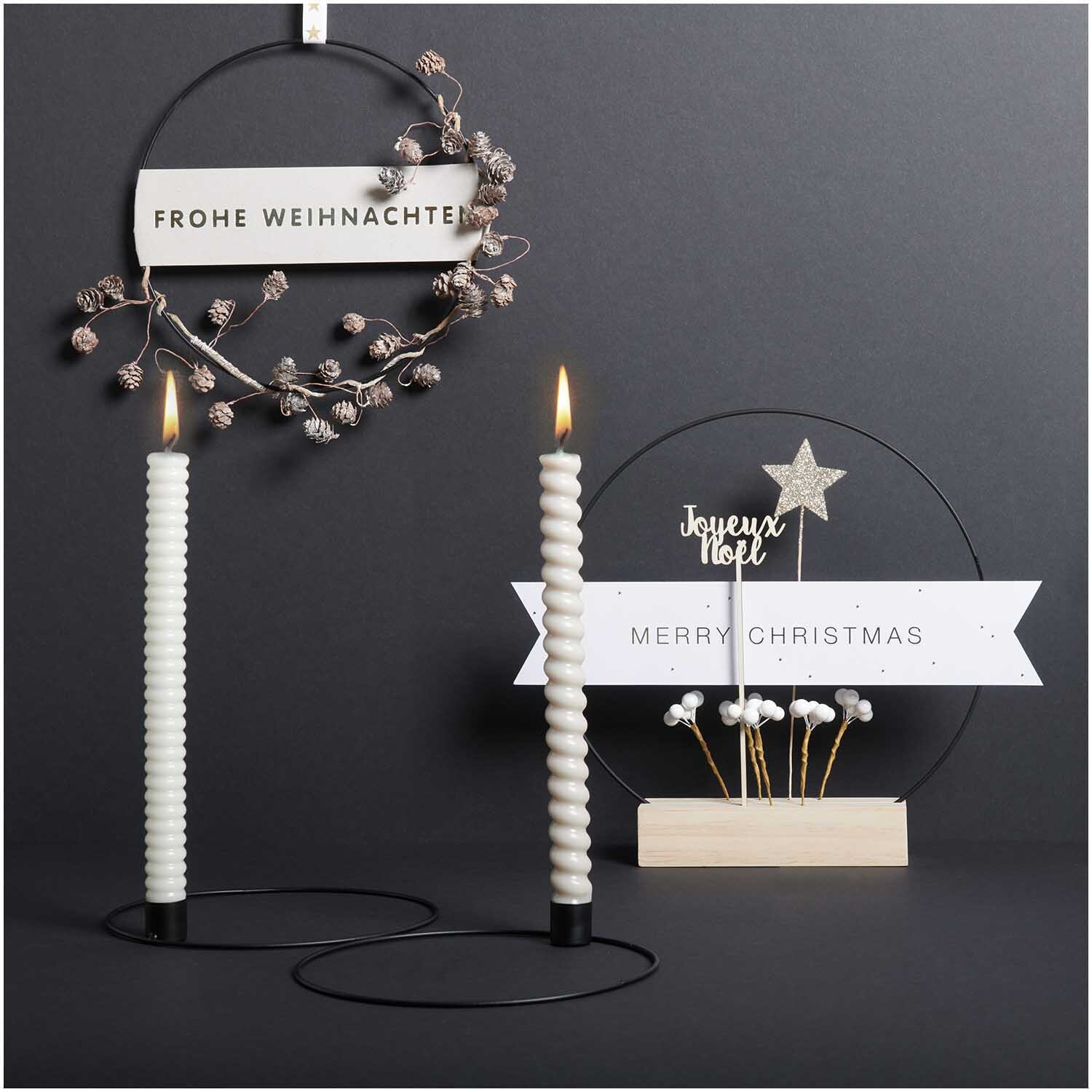 Metallring mit Kerzenhalter Ø 20cm Farbe Gold Matt von Rico Design Metallring mit Kerzenhalter Ø 20cm, dekoriert mit weißen Kerzen und weihnachtlichen Elementen auf schwarzem Hintergrund.