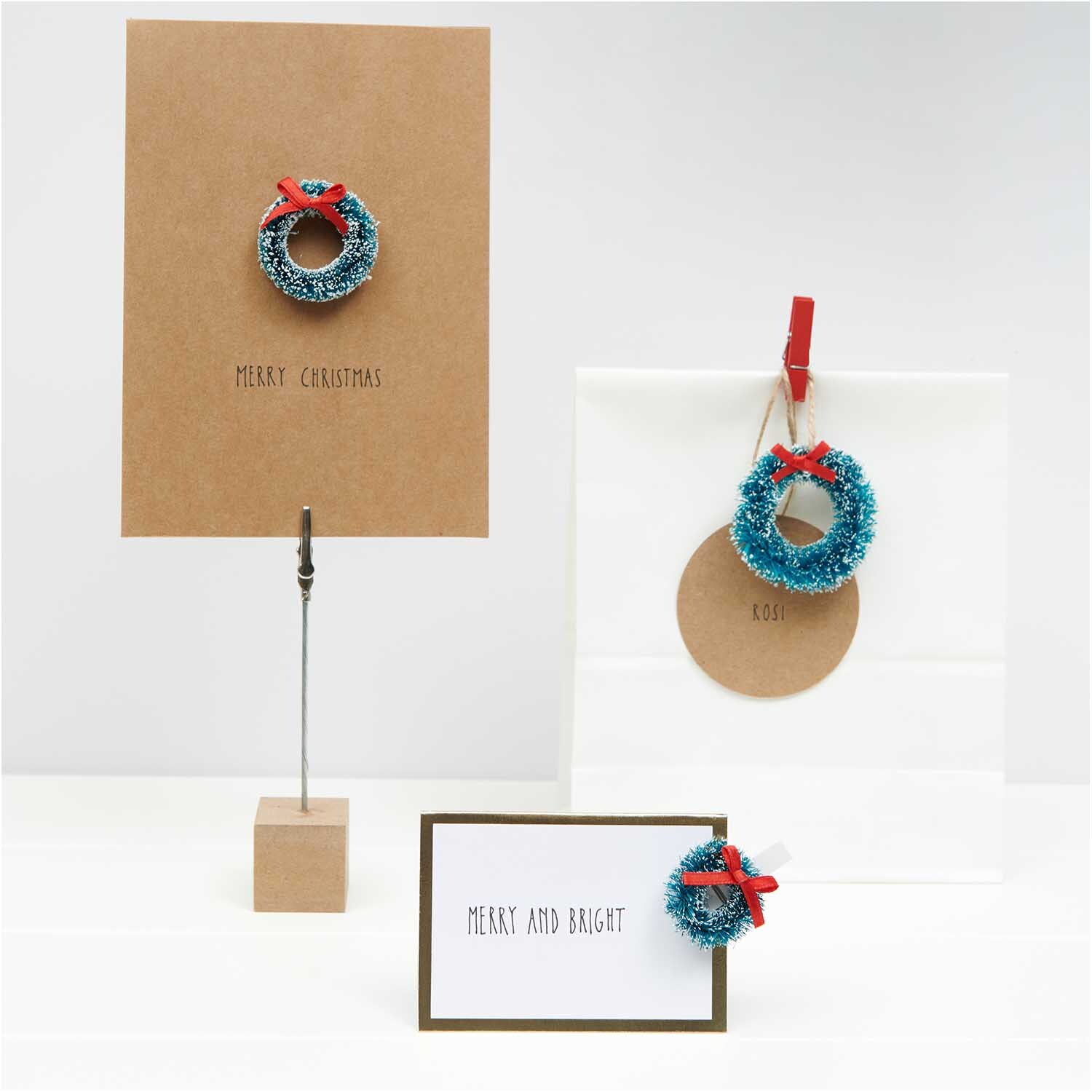 Paper Poetry Tischkarten mit Hot Foil zeigen festliche Kränze und Grüße in elegantem Design.