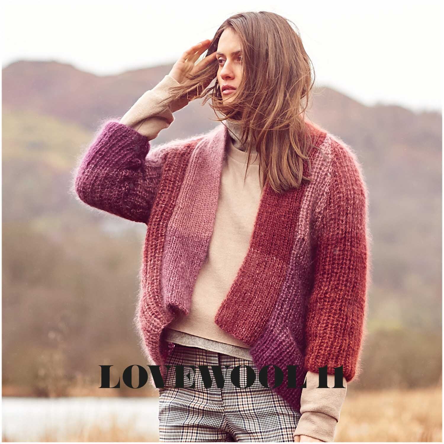 Essentials Super Kid Mohair Loves Silk Colourlove 100g 265m Couleur Baie from Rico Design Essentials Super Kid Mohair Loves Silk Colourlove: Frau in beerenfarbener Strickjacke von Rico Design in herbstlicher Landschaft.