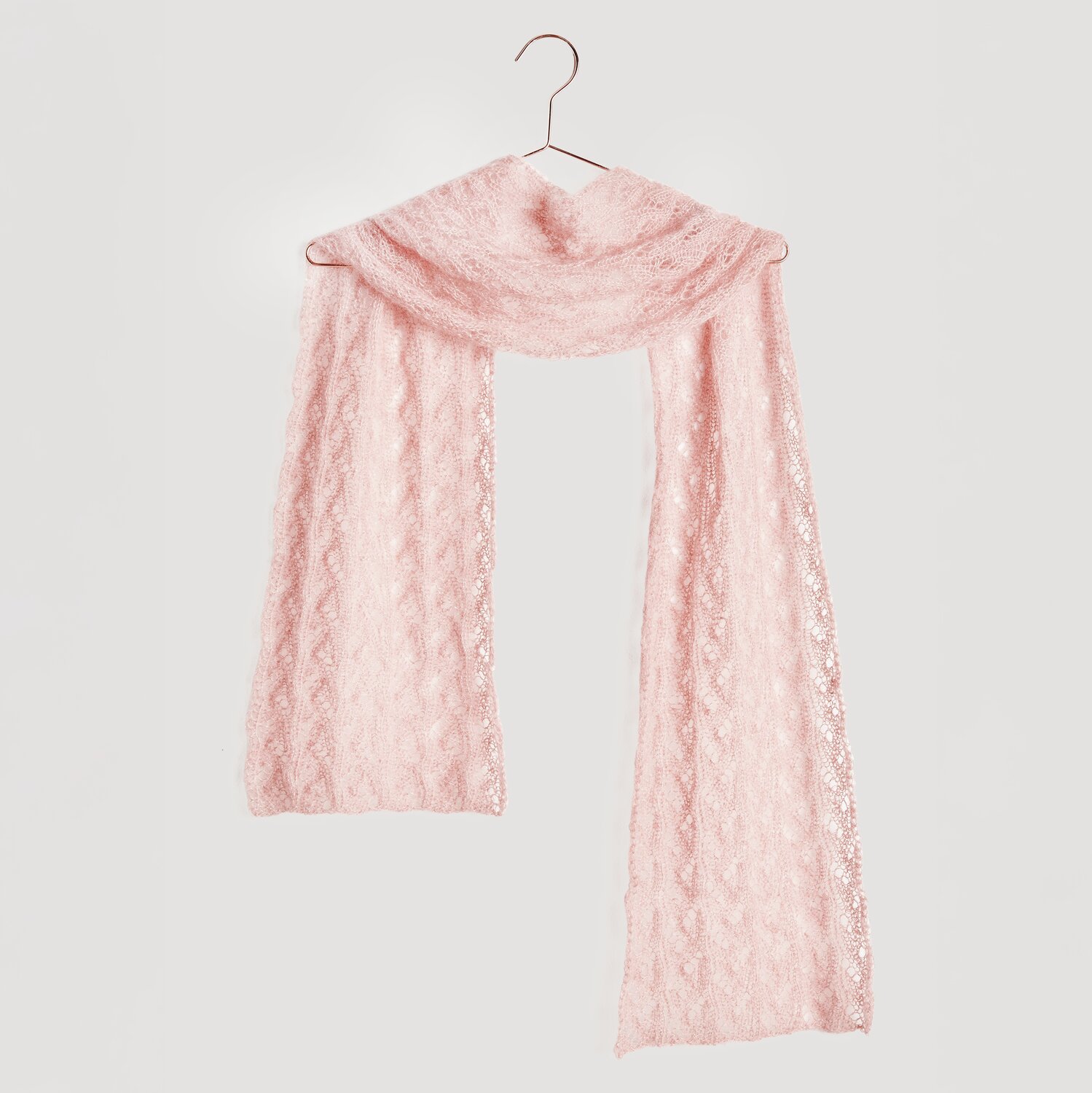 Essentials Super Kid Mohair Loves Silk Glamorous Glitter 25g 190m Farbe Beere von Rico Design Strickset Tuch Modell 13: Zartes, rosa Tuch aus Mohair-Seide-Mischung, elegant drapiert auf einem Kleiderbügel.