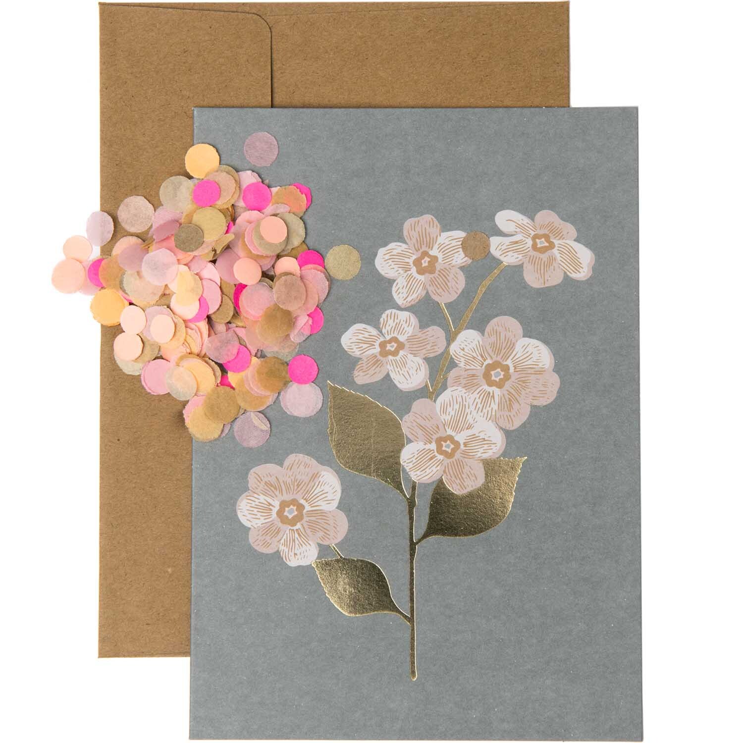Paper Poetry Grußkartenset mit Magnolienmotiv auf dunkelgrauem Hintergrund, begleitet von buntem Konfetti. Ideal für stilvolle Grüße.