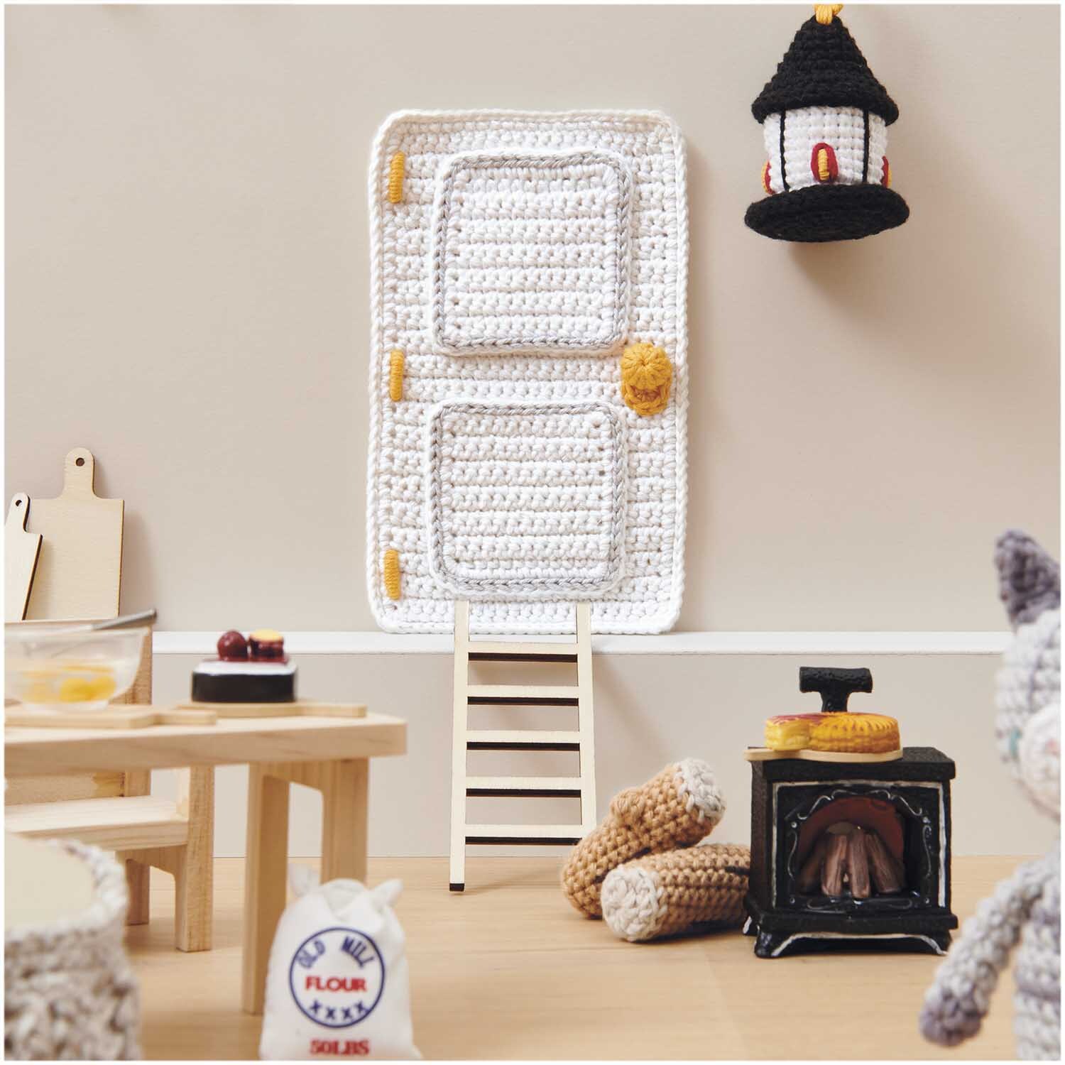Miniatur Kamin mit Licht 7x4,8x2,2cm von Rico Design Miniatur Kamin mit Licht in einer gemütlichen Puppenhausküche, umgeben von gehäkelten Accessoires.