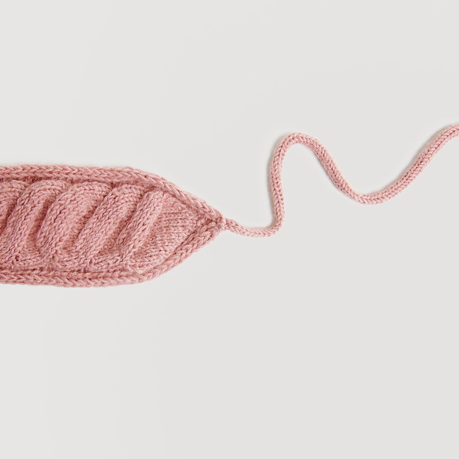 Essentials Super Kid Mohair Loves Silk Glamorous Glitter 25g 190m Farbe Beere von Rico Design Essentials Merino dk, gestricktes Blatt in Perlrosa, zeigt feine Details und weiche Textur. Ideal für kreative Strickprojekte.