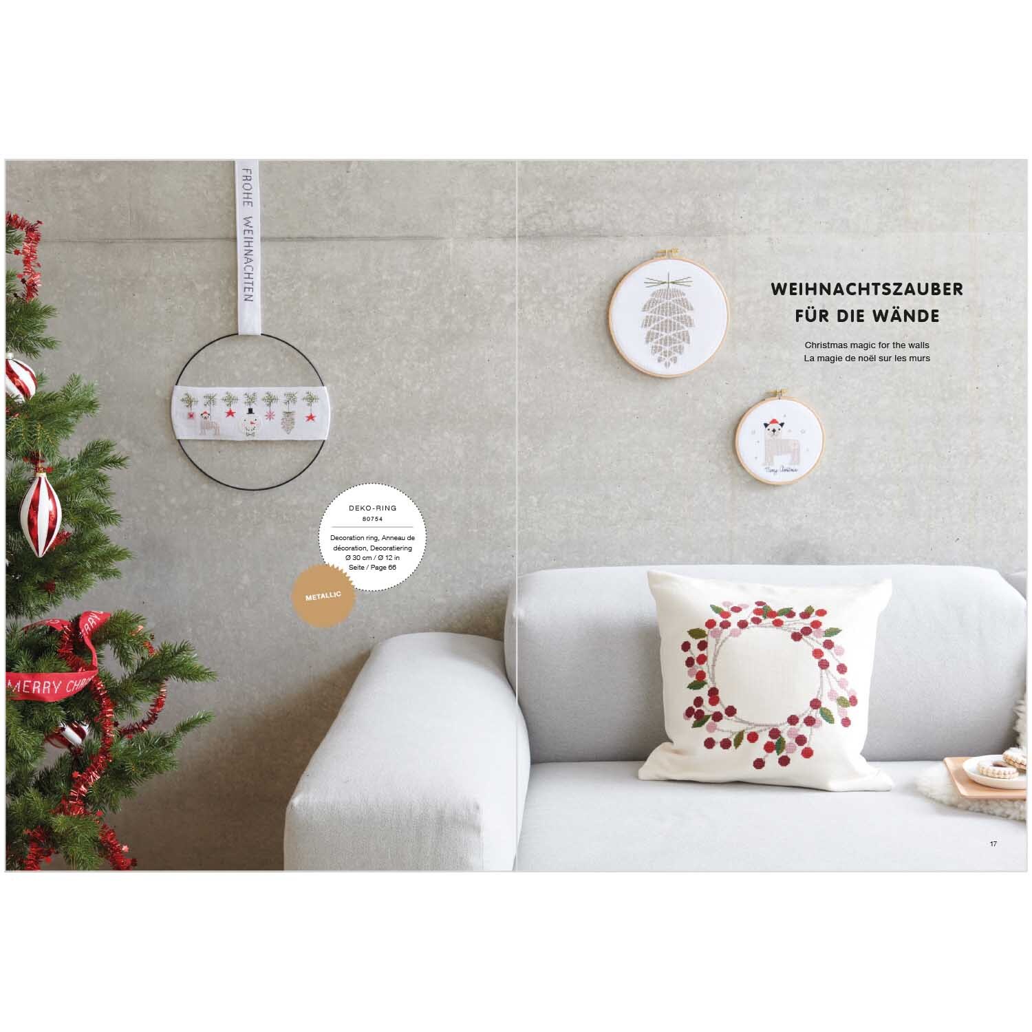 Livret de broderie I love Christmas No. 180 from Rico Design Stickbuch I love Christmas Nr. 180: Weihnachtliche Wanddekoration mit Stickrahmen und Kissen von Rico Design neben einem geschmückten Baum.