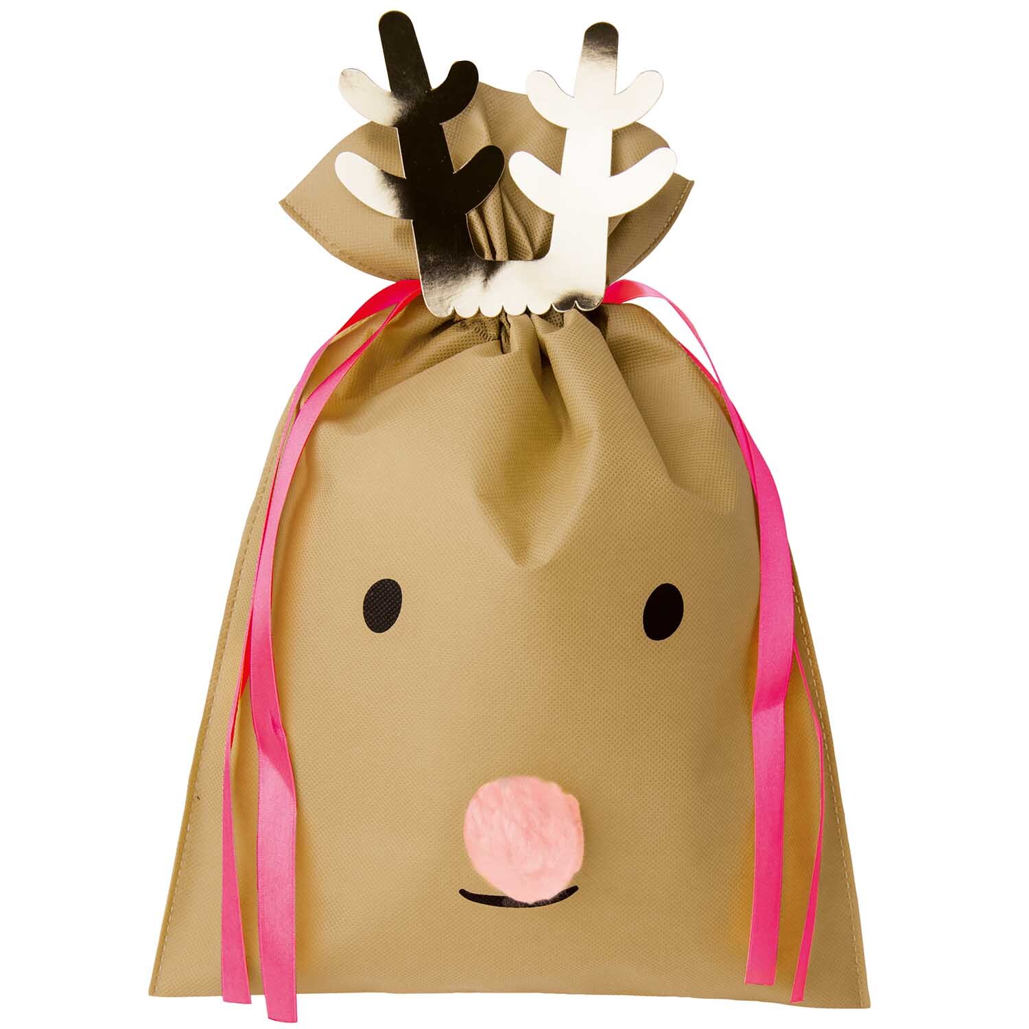 Paper Poetry Geschenktüte mit Rentiermotiv, verziert mit rosa Bändern und Geweih, ideal für Weihnachtsgeschenke.
