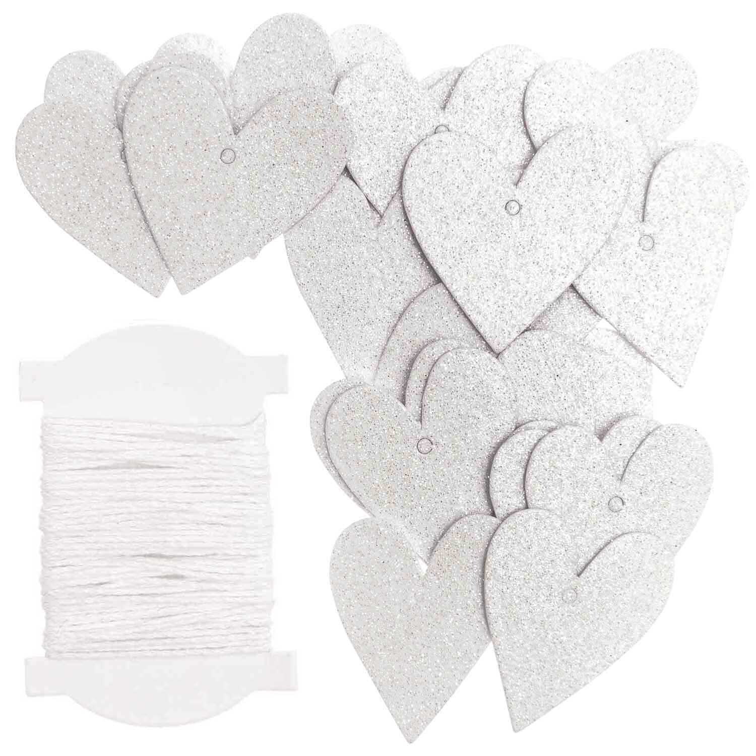 Paper Poetry Papieranhänger in Herzform mit Glitter, 24 Stück, neben weißem Faden arrangiert. Ideal für kreative Dekorationen.
