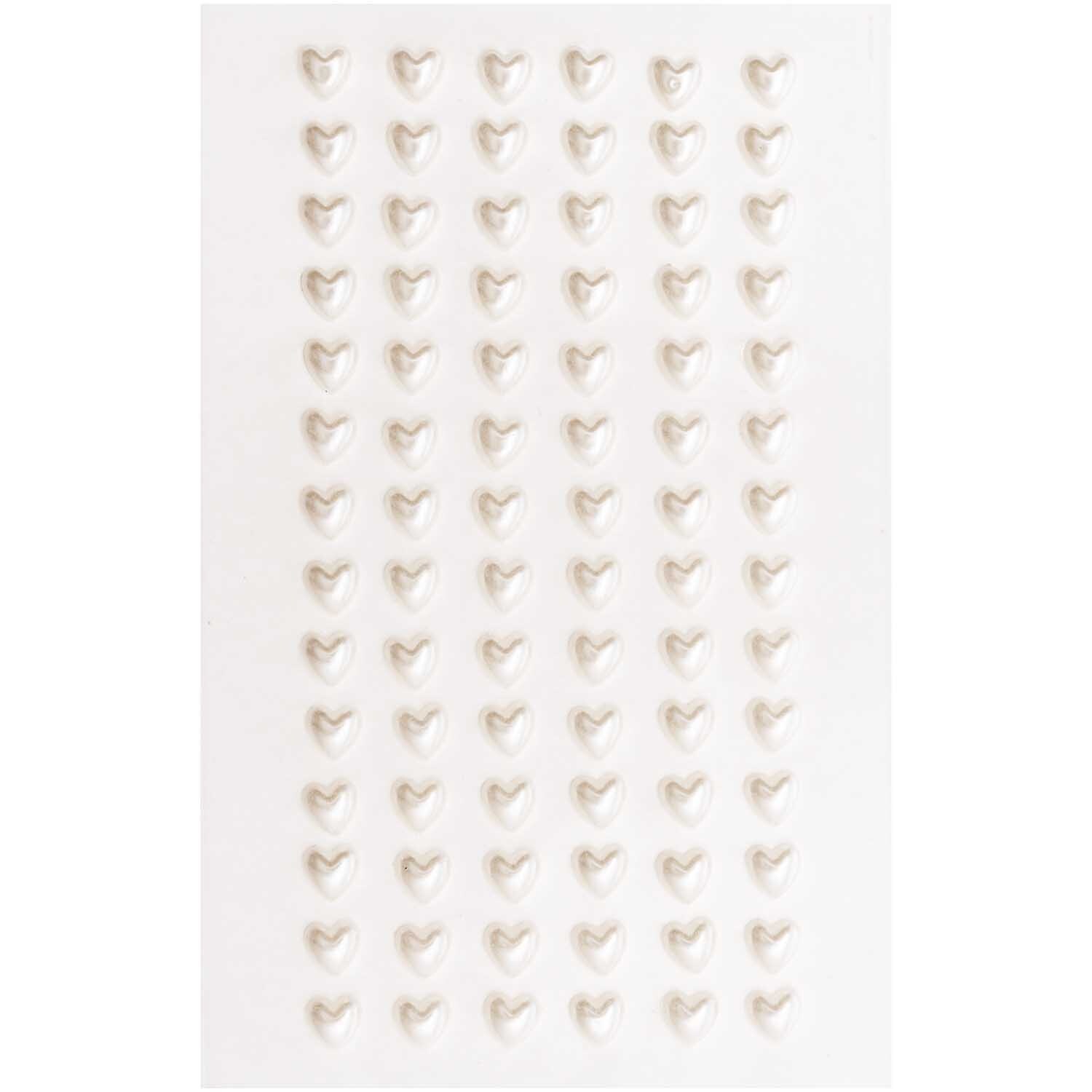 Paper Poetry Perlensticker Herzen, 84 Stück, zeigen weiße Herzsticker auf einem Blatt von Rico Design. Ideal für kreative Projekte.