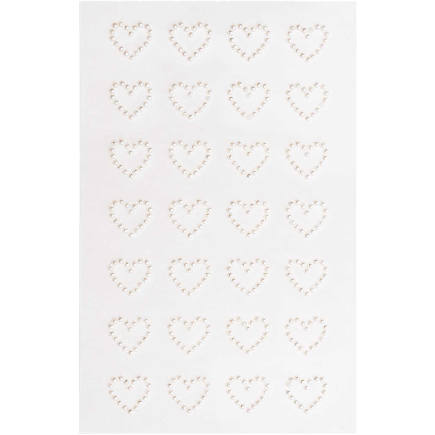 Paper Poetry Perlensticker Herzen S von Rico Design zeigen weiße Herzsticker auf einem Blatt. Ideal für kreative Bastelprojekte.