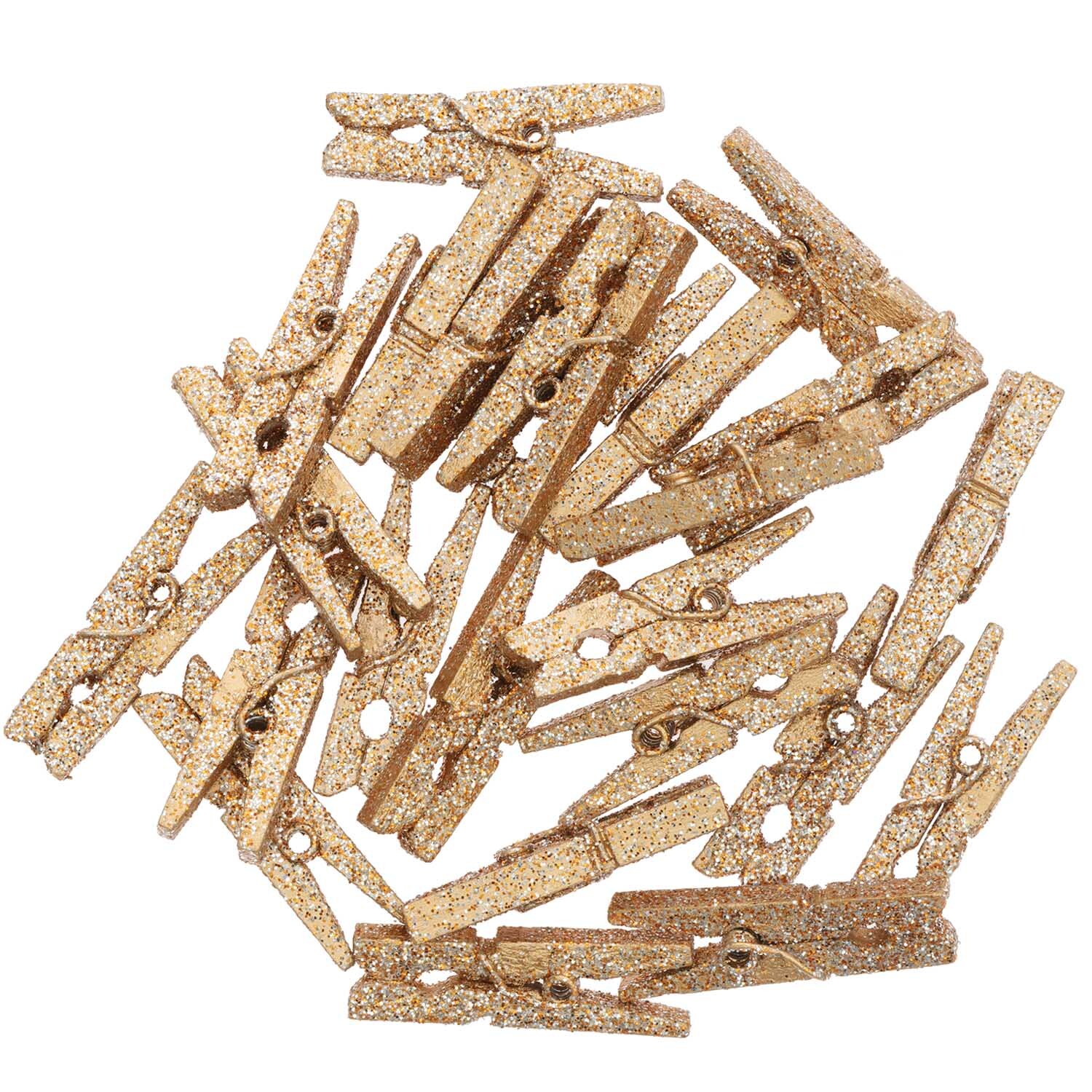 Holzklammern mit Glitter 4x30mm 24 Stück, dekorative goldene Klammern von Rico Design auf schwarzem Hintergrund.