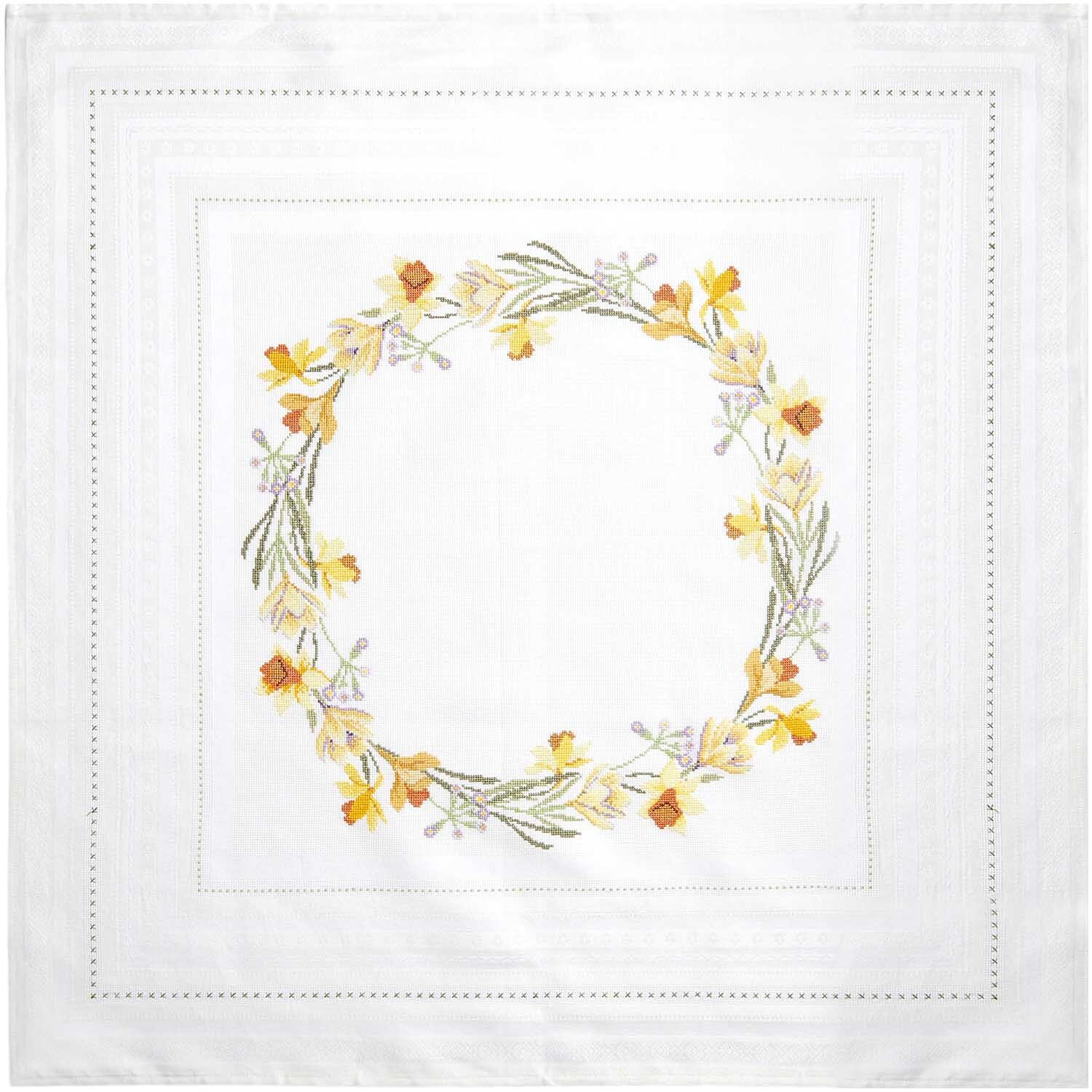 Stickpackung Tischdecke Frühlingskranz von Rico Design zeigt einen bunten Blumenkranz auf weißem Stoff, 90x90cm.
