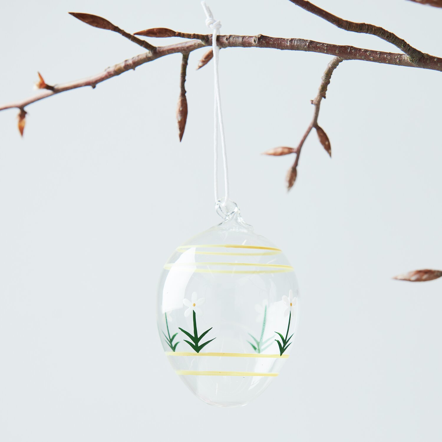 Glas Ei Blumen handbemalt Ø6x9cm von Rico Design Glas Ei Blumen handbemalt von Rico Design, hängend an einem Ast, mit zarten Blumenmotiven.